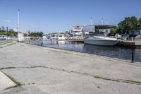 boats in the harbor, with a boat dock on either side of it and a boat ramp to the right