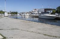 boats in the harbor, with a boat dock on either side of it and a boat ramp to the right