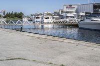 boats in the harbor, with a boat dock on either side of it and a boat ramp to the right