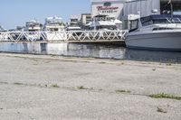 boats in the harbor, with a boat dock on either side of it and a boat ramp to the right