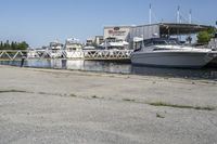 boats in the harbor, with a boat dock on either side of it and a boat ramp to the right