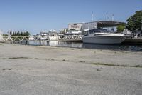 boats in the harbor, with a boat dock on either side of it and a boat ramp to the right