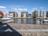 there are several boats on the water in this harbor area of an apartment complex or town