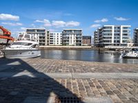 there are several boats on the water in this harbor area of an apartment complex or town