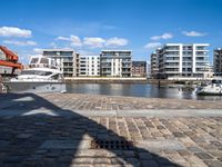 there are several boats on the water in this harbor area of an apartment complex or town