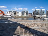 there are several boats on the water in this harbor area of an apartment complex or town