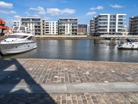 there are several boats on the water in this harbor area of an apartment complex or town