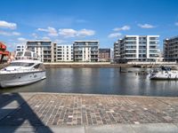 there are several boats on the water in this harbor area of an apartment complex or town