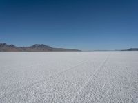 a barren plain with hills in the background on a sunny day during winter months with no snow,