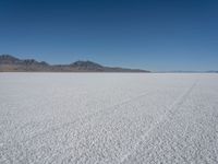 a barren plain with hills in the background on a sunny day during winter months with no snow,