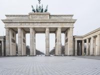 the people ride bicycles in front of the large building with many pillars and pillars behind it