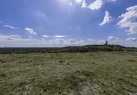 the landscape looks out over the open space on the horizon of land and clouds above it