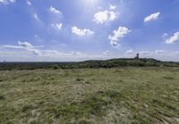 the landscape looks out over the open space on the horizon of land and clouds above it