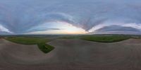 the 360 - view image is shown on the skateboard ramp near a field at sunset