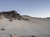 rocks and stones are arranged around a small mound on a barren hill above the desert