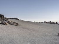 rocks and stones are arranged around a small mound on a barren hill above the desert