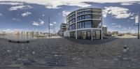 a building is shown in this 360 - angle photo with the sky in the background