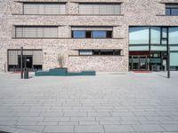 a brick building with windows and large pots on the ground in front of it for privacy