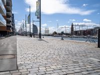 the empty city has large stone walkways that connect with the water and sky in the distance