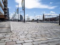 the empty city has large stone walkways that connect with the water and sky in the distance