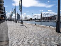 the empty city has large stone walkways that connect with the water and sky in the distance