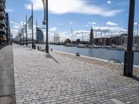 the empty city has large stone walkways that connect with the water and sky in the distance