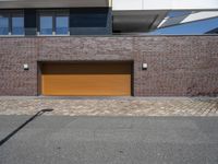 a brick and metal garage that has two doors open to allow people to sit inside