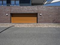 a brick and metal garage that has two doors open to allow people to sit inside