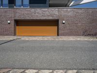 a brick and metal garage that has two doors open to allow people to sit inside