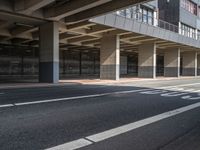 a large garage overpass with several windows in it and sign on the side of the road