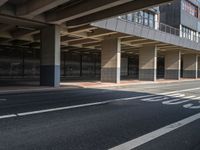 a large garage overpass with several windows in it and sign on the side of the road