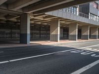 a large garage overpass with several windows in it and sign on the side of the road