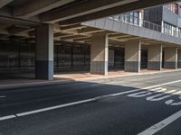 a large garage overpass with several windows in it and sign on the side of the road