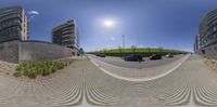 a fish eye view of cars in front of building and building lot with grass on the outside