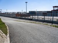 a street with a construction site in the distance behind it, and another city that is nearby