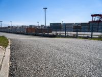 a street with a construction site in the distance behind it, and another city that is nearby