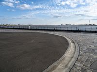 a concrete curb with a street corner next to it and sky in the background and on the ground there is a long exposure