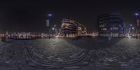 two circular images with a view of a city at night, taken from a fish eye