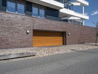 an exterior view of a building with a brick driveway and large sliding door for a garage