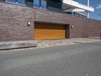 an exterior view of a building with a brick driveway and large sliding door for a garage