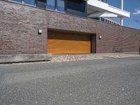 an exterior view of a building with a brick driveway and large sliding door for a garage