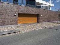 an exterior view of a building with a brick driveway and large sliding door for a garage