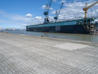 an image of a dock near a big ship in the water in front of a dock