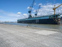 an image of a dock near a big ship in the water in front of a dock