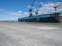 an image of a dock near a big ship in the water in front of a dock