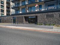 street with concrete side and black buildings on the side and an open area to the ground