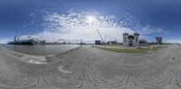 a fish eye view of the city from a pier by water and buildings on a sunny day