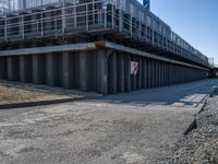 this concrete walkway has a ramp on top of it for access to a large storage area