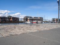 there's a bench in front of a harbor with sail boats docked by the harbor