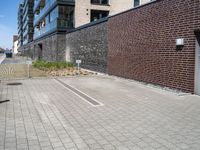 a brick building with a parking lot in front of it and an opening door behind it